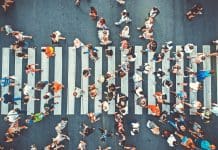 Dementia in Europe to soar 64% by 2050, Alzheimer’s report warns Aerial. People crowd on pedestrian crosswalk. Top view background. Toned image.