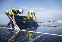 Rooftop solar could meet 40% of the EU’s long-term electricity demand Two engineers installing solar panels on roof.