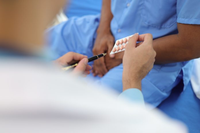 Doctor gives medication advice to a male patient with symptoms of sexual dysfunction, Male health problems. Health consultants and disease treatment from specialized doctors in the hospital.