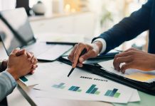 BBSRC Sparking Innovation Conference 2026 returns to Leicester Business people, hands and documents with laptop or statistics for company profit, growth or graph at office. Closeup, employees or analyst pointing with chart for financial revenue or performance