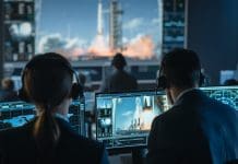 Group of People in Mission Control Center Witness Successful Space Rocket Launch. Flight Control Employees Sit in Front Computer Displays and Monitor the Crewed Mission.