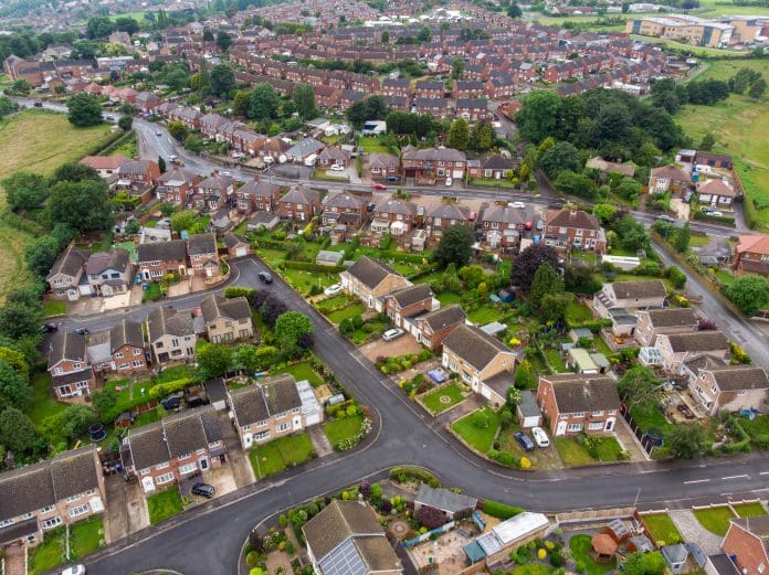 Aerial photo of the UK town of Worsbrough in Barnsley South Yorkshire, England showing rows of houses, roads and a typical British housing estates on a sunny day