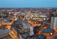 Captured with the DJI Mini 3 Pro, this stunning aerial image showcases Birmingham City Centre bathed in the soft, atmospheric glow of blue hour. The fading twilight casts a deep indigo hue over the skyline, while the city below begins to sparkle with life. Skyscrapers and historic buildings alike are illuminated, their windows glowing warmly against the cool tones of the evening sky. The iconic BT Tower and the modern silhouettes of the Library of Birmingham and The Cube stand out prominently, reflecting the vibrant pulse of the city. Streetlights trace the roads like glowing veins, and the last light of day gently kisses the horizon, creating a striking contrast between natural dusk and the artificial brilliance of the urban landscape.