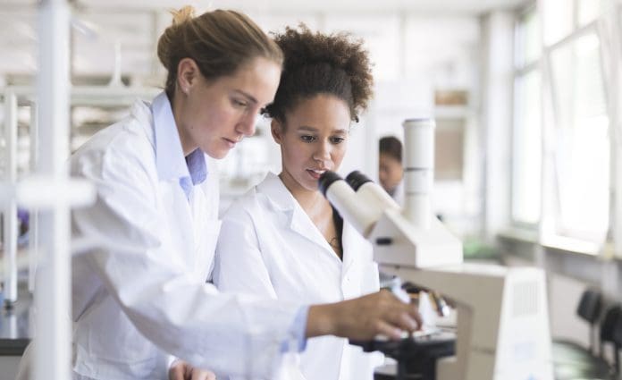 Scientists using a microscope