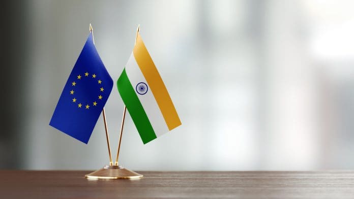 European Union And Indian Flag Pair On A Desk Over Defocused Background